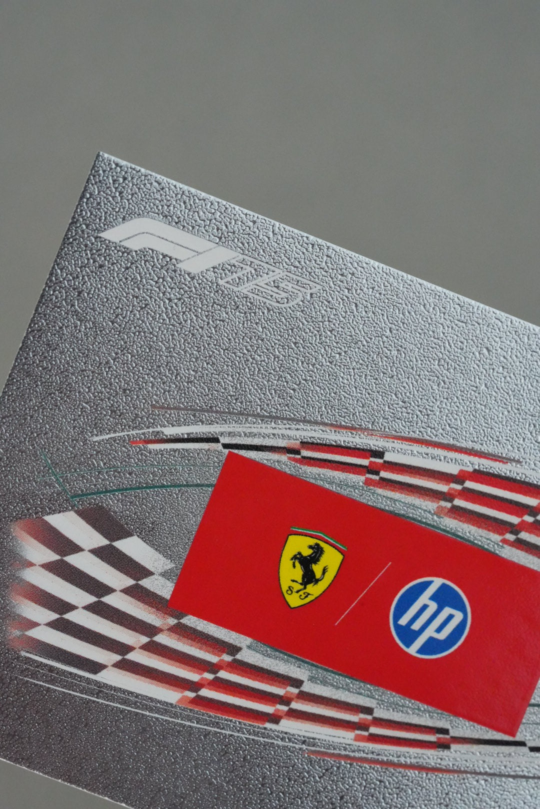 Close-up of F1 75 logo and foil finish on Ferrari HP team card from Turbo Attax 2025