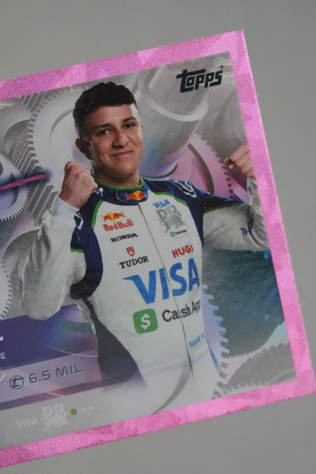Detail view of Isack Hadjar’s portrait on F1 Turbo Attax 2025 pink holo card, showing sponsor logos