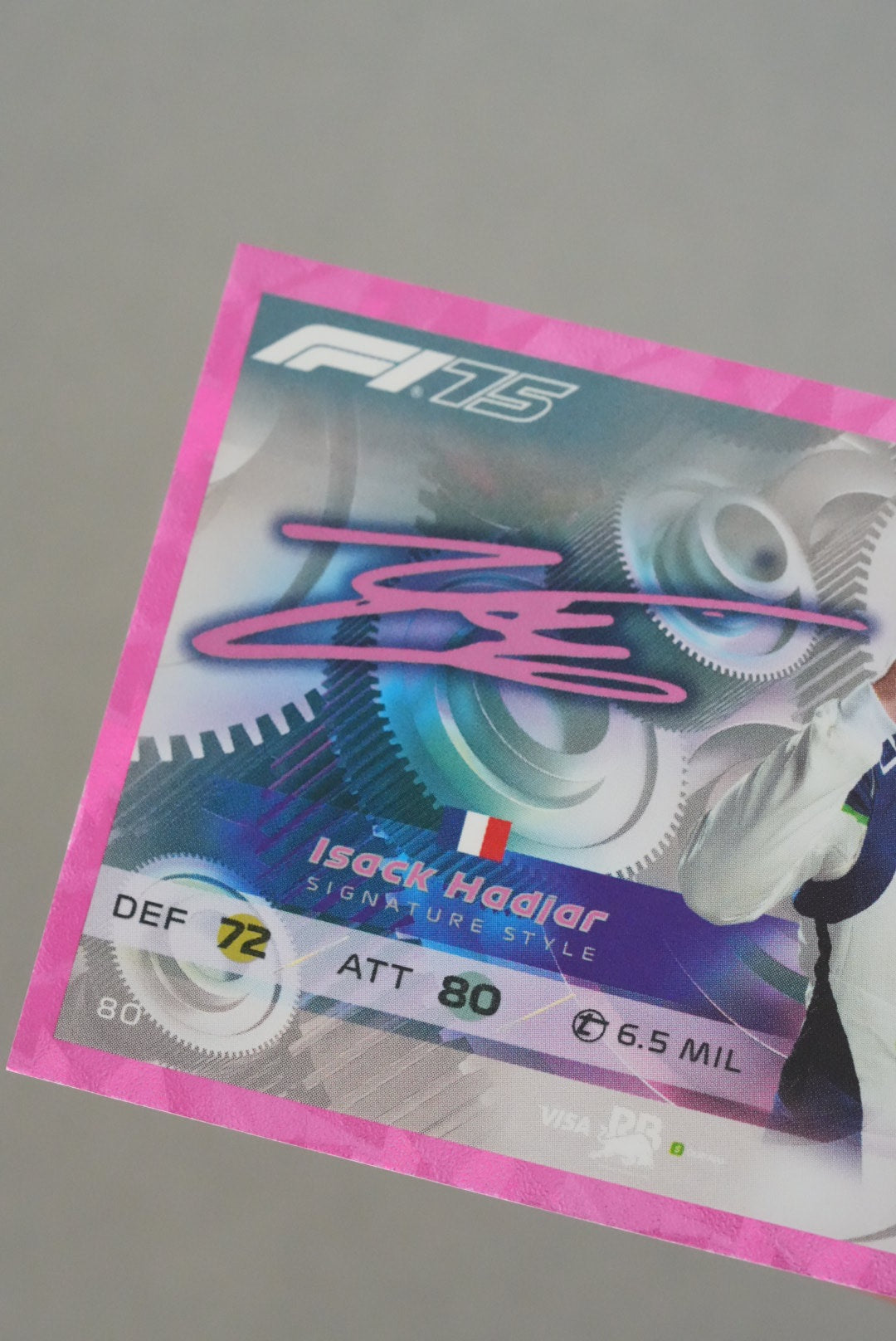 Close-up of Isack Hadjar F1 card showing holographic signature and defensive rating of 72
