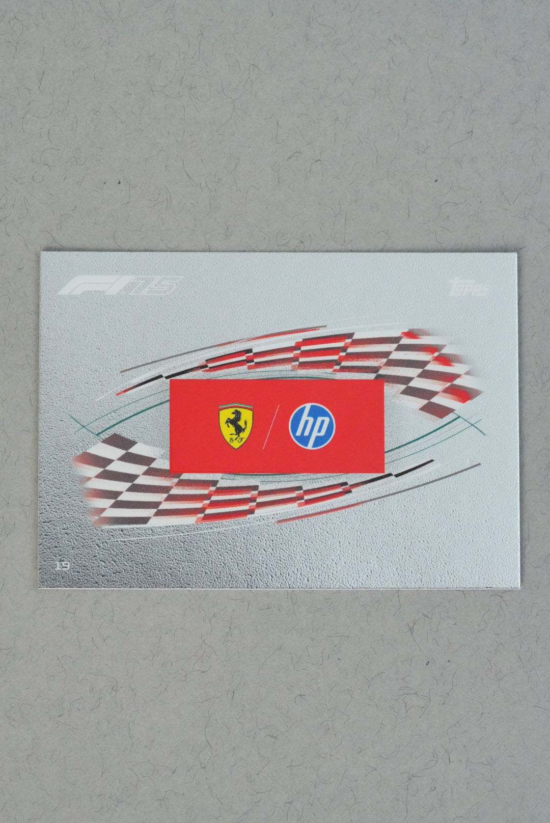 Scuderia Ferrari HP team logo mirror foil card number 19 from Turbo Attax 2025