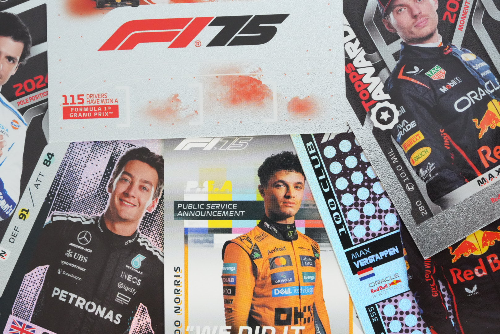 Close-up of 2025 Topps Turbo Attax F1 trading cards featuring Max Verstappen, George Russell, and Lando Norris with F1 75 logo